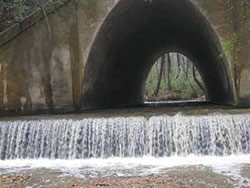 Dam at Nickajack Creek with railroad overpass in background